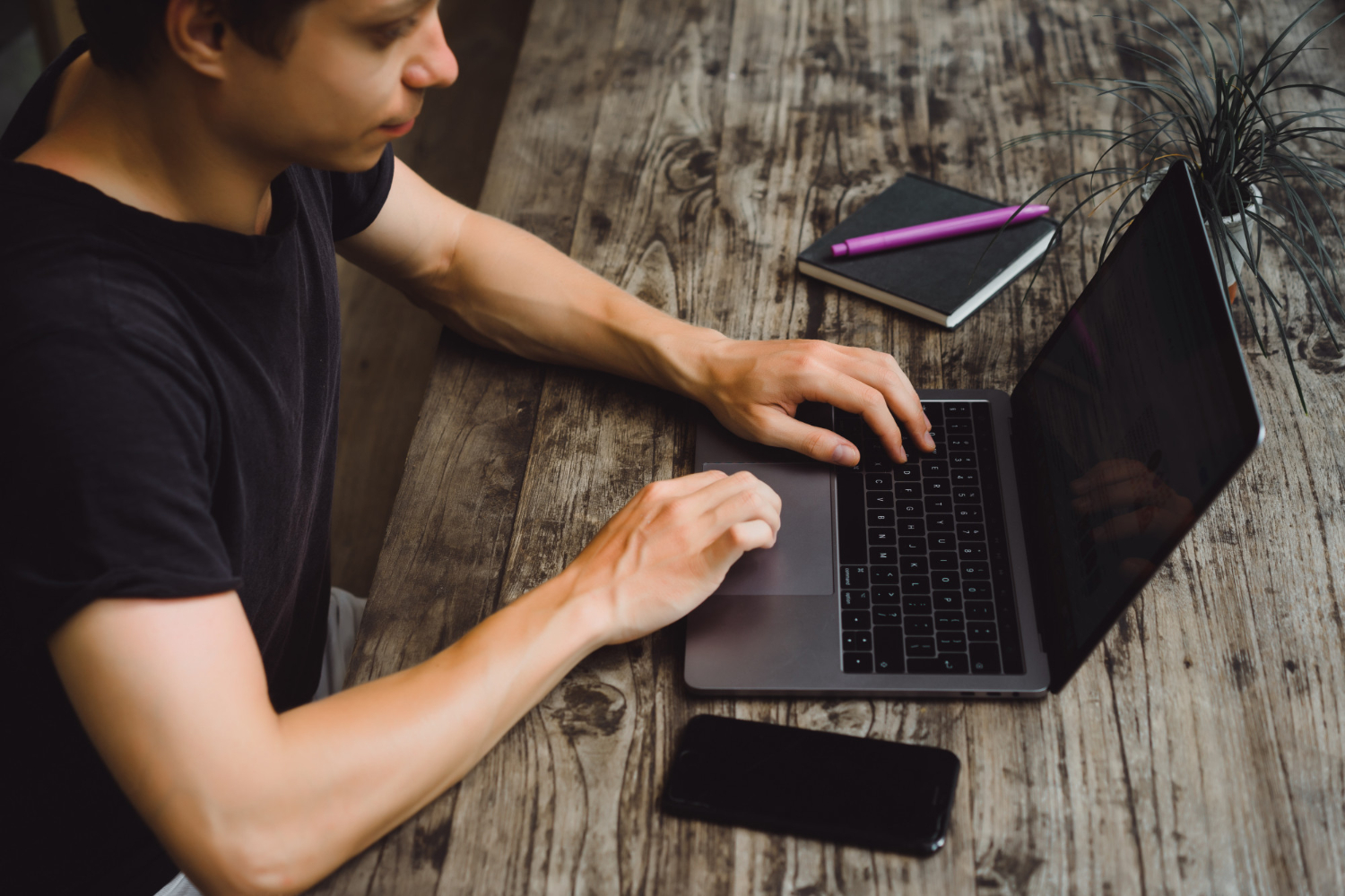 the guy is working on a laptop